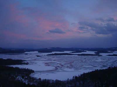 Sunset colors tinting the ice of Squam Lake as seen from West Rattlesnake - Click to enlarge