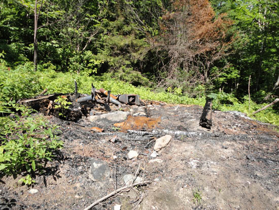 The remains of the recently burned Fire Warden's cabin