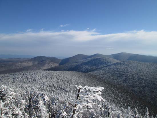 Unknown Pond Peak, The Horn, The Bulge, Mt. Cabot (background) and the Pilot Range as seen from the southern Hutchins ledges - Click to enlarge