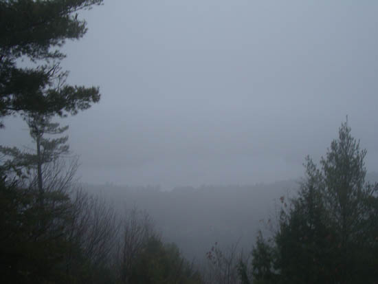 Looking through the fog at Winnisquam Lake from the Ladd Mountain ledge vista - Click to enlarge