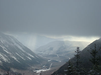 Looking under rising clouds toward Webster Cliff and Route 302 from Mt. Avalon - Click to enlarge