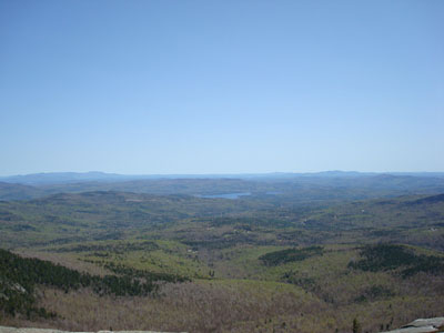 Looking east towards the Ossipee Range, Lake Winnipesaukee, and the Belknap Range from the Mt. Cardigan summit - Click to enlarge