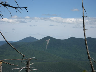 Looking southeast toward Mt. Tripyramid from the wooded East Peak summit of Mt. Osceola - Click to enlarge