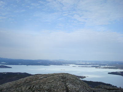 Looking over Lake Winnipesaukee at the Ossipee Mountains from the Mt. Major summit - Click to enlarge