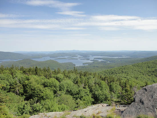 Looking at Squam Lake, Lake Winnipesaukee, and the Belknap Range from the Mt. Morgan ledges - Click to enlarge