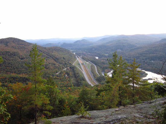 Looking south at I-93's Tripoli Road exit from the southern Russell Crag ledges - Click to enlarge