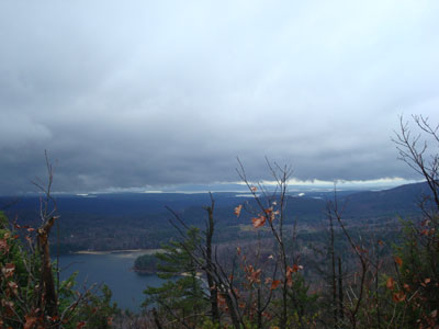 Looking at Lake Winnipesaukee (in the distance under the clouds) from the ledges of Sentinel Mountain - Click to enlarge