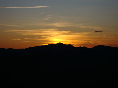 The sun setting behind Mt. Carrigain as seen from South Doublehead - Click to enlarge