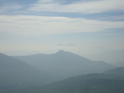 Looking at the Percy Peaks, as well as the Presidentials in a smoke undercast, from Sugarloaf - Click to enlarge